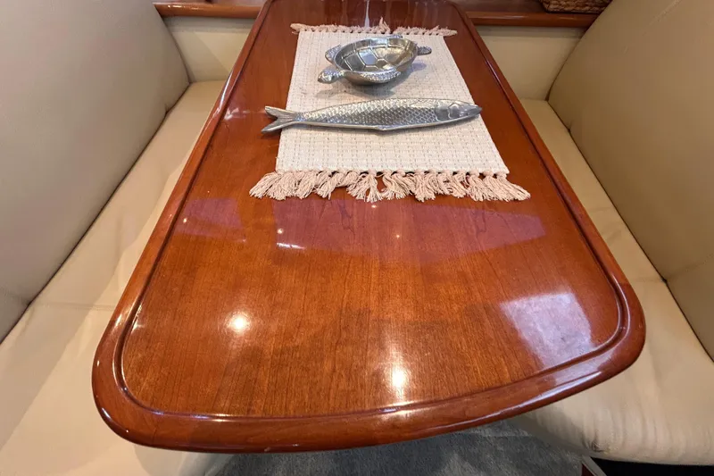 Slide: The Image of Elegant wooden table with decorative items on a 2005 Carver 36 Motor Yacht. - 92