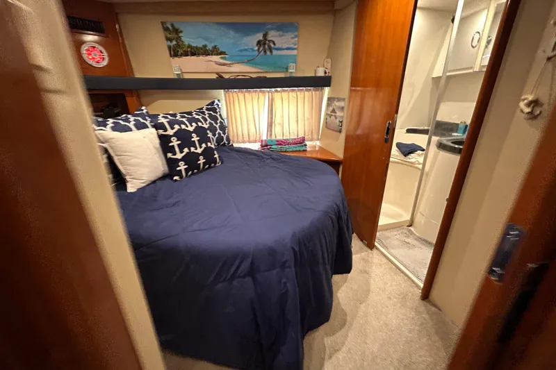 Slide: The Image of Cozy bedroom in 2005 Carver 36 Motor Yacht with nautical decor and ensuite bathroom. - 120