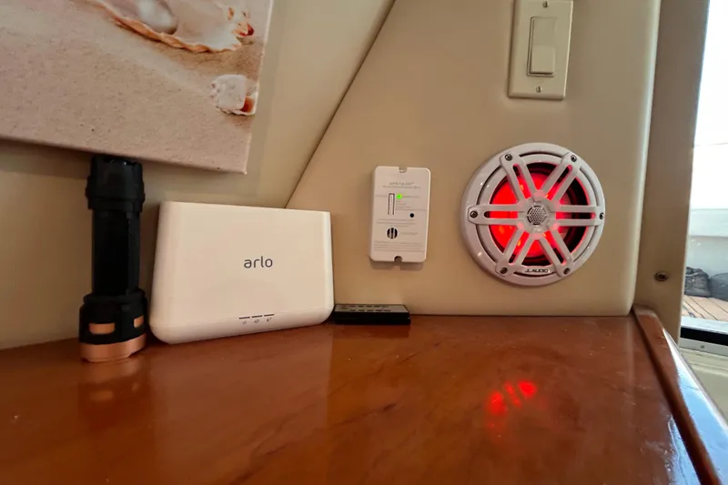 Slide: The Image of 2005 Carver 36 Motor Yacht interior with Arlo device, flashlight, and JL Audio speaker. - 111