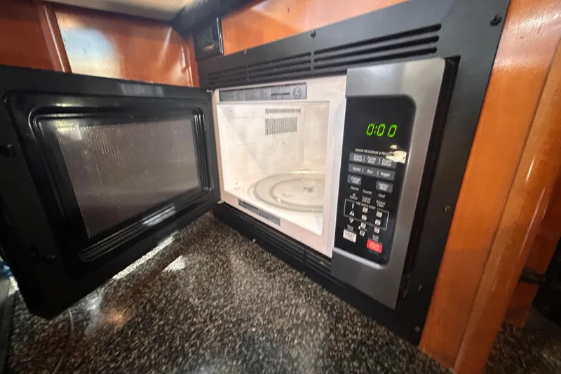 Slide: The Image of Microwave oven inside 2005 Carver 36 Motor Yacht, with open door and digital display. - 82
