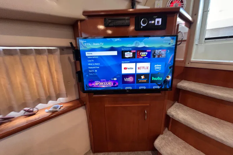 Slide: The Image of Interior of 2005 Carver 36 Motor Yacht with mounted Roku TV displaying streaming apps. - 109