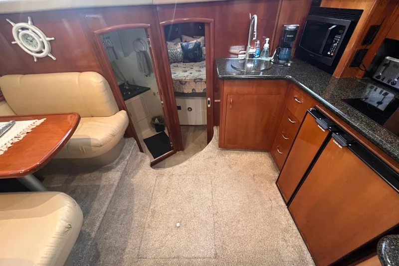 Slide: The Image of Interior of 2005 Carver 36 Motor Yacht with kitchen, seating, and bedroom view. - 72