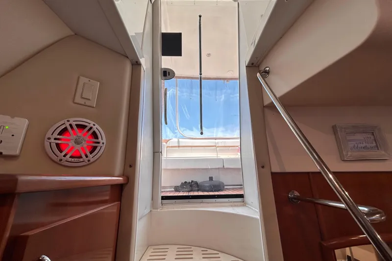 Slide: The Image of Interior view of 2005 Carver 36 Motor Yacht, featuring stairs and a red-lit speaker. - 137