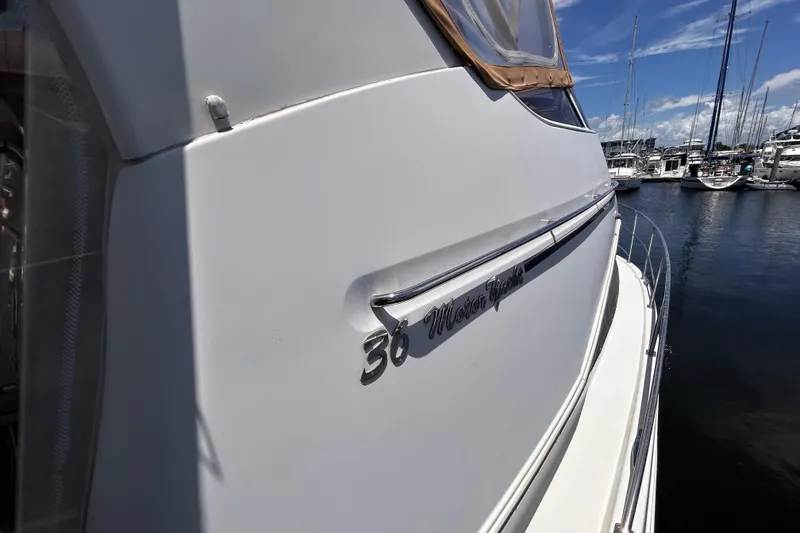 Slide: The Image of 2005 Carver 36 Motor Yacht docked at marina under clear blue sky. - 14