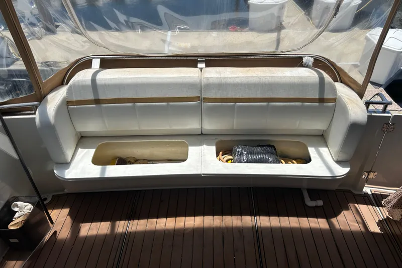 Slide: The Image of 2005 Carver 36 Motor Yacht interior with white seating and storage compartments. - 20
