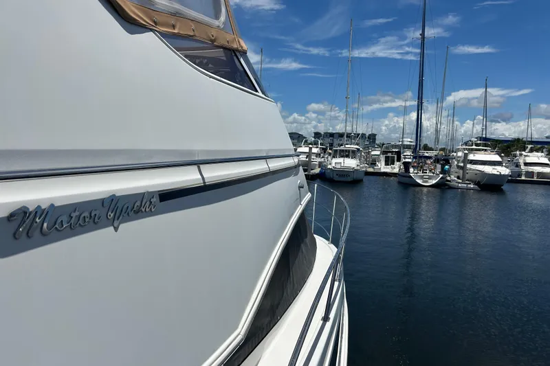 Slide: The Image of 2005 Carver 36 Motor Yacht docked at marina under clear blue sky. - 151
