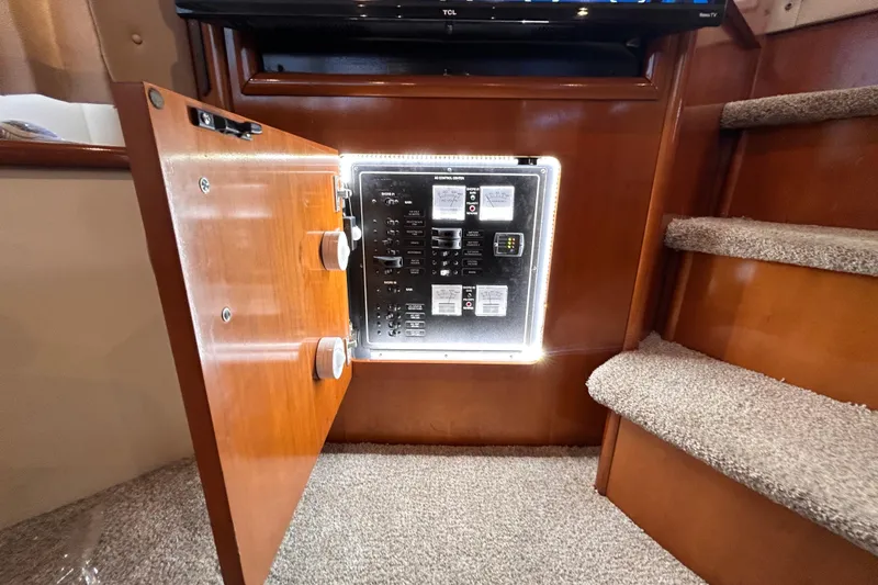 Slide: The Image of Electrical panel inside a 2005 Carver 36 Motor Yacht, near carpeted stairs. - 112