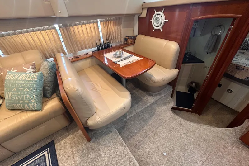 Slide: The Image of Interior of 2005 Carver 36 Motor Yacht with plush seating and dining area. - 89