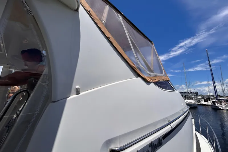 Slide: The Image of 2005 Carver 36 Motor Yacht docked at marina under clear blue sky. - 13
