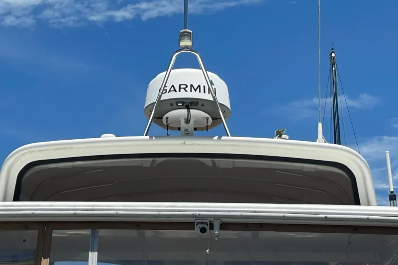 Slide: The Image of Radar equipment on a 2005 Carver 36 Motor Yacht under a clear blue sky. - 145