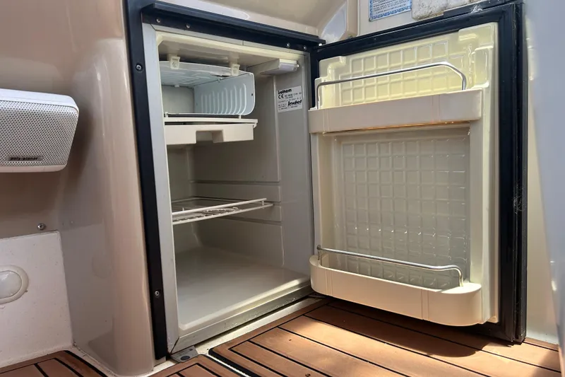 Slide: The Image of Open refrigerator on 2005 Carver 36 Motor Yacht, showcasing interior storage space. - 51