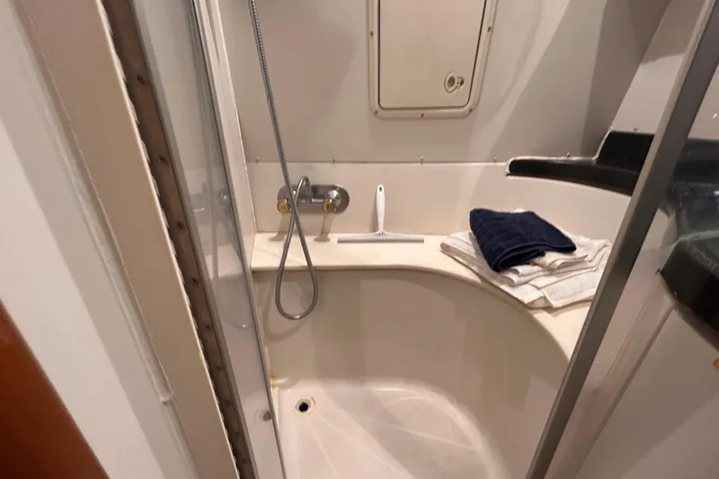 Slide: The Image of Shower area in 2005 Carver 36 Motor Yacht with towels and cleaning tool. - 126