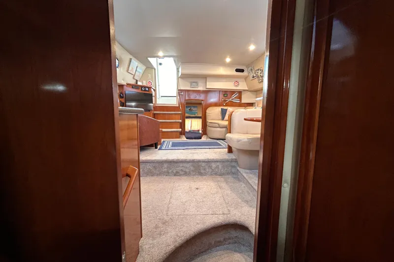 Slide: The Image of Interior of 2005 Carver 36 Motor Yacht, featuring cozy seating and elegant wood finishes. - 104
