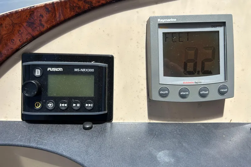 Slide: The Image of Control panel of a 2005 Carver 36 Motor Yacht with depth and audio displays. - 29