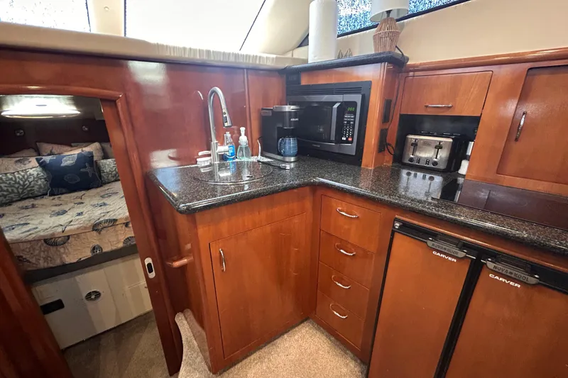 Slide: The Image of Luxurious kitchen area in a 2005 Carver 36 Motor Yacht with modern appliances. - 78