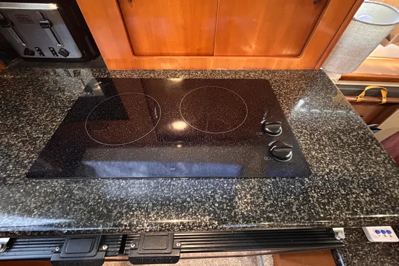 Slide: The Image of Black stovetop on granite counter in 2005 Carver 36 Motor Yacht kitchen. - 77