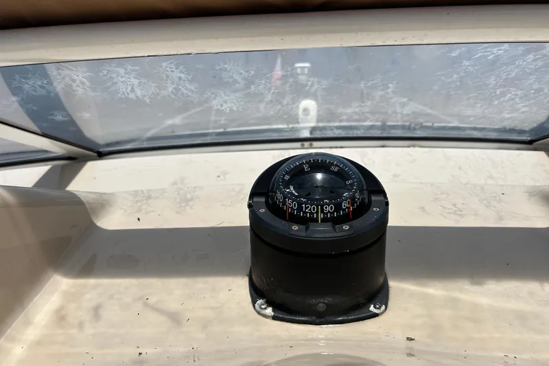 Slide: The Image of Compass on 2005 Carver 36 Motor Yacht dashboard, under a slightly frosted windshield. - 37
