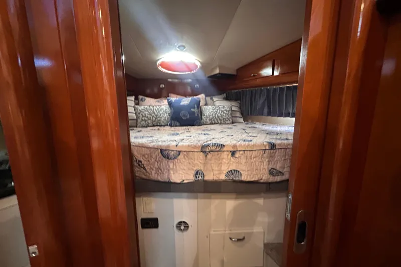 Slide: The Image of Cozy bedroom interior of 2005 Carver 36 Motor Yacht with nautical-themed bedding. - 95