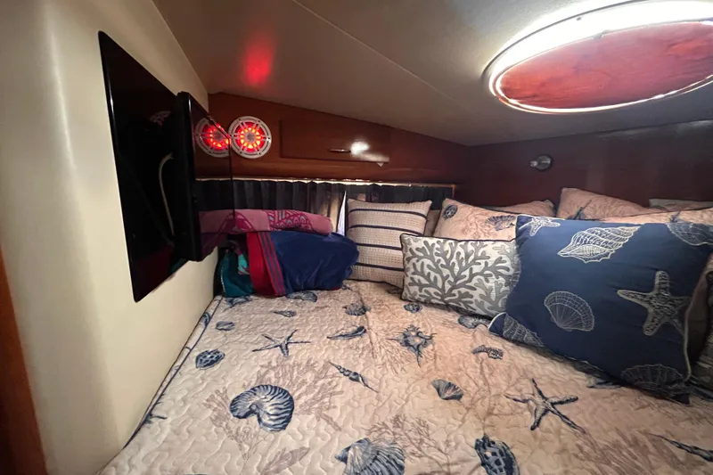 Slide: The Image of Cozy cabin interior of 2005 Carver 36 Motor Yacht with nautical-themed bedding. - 98