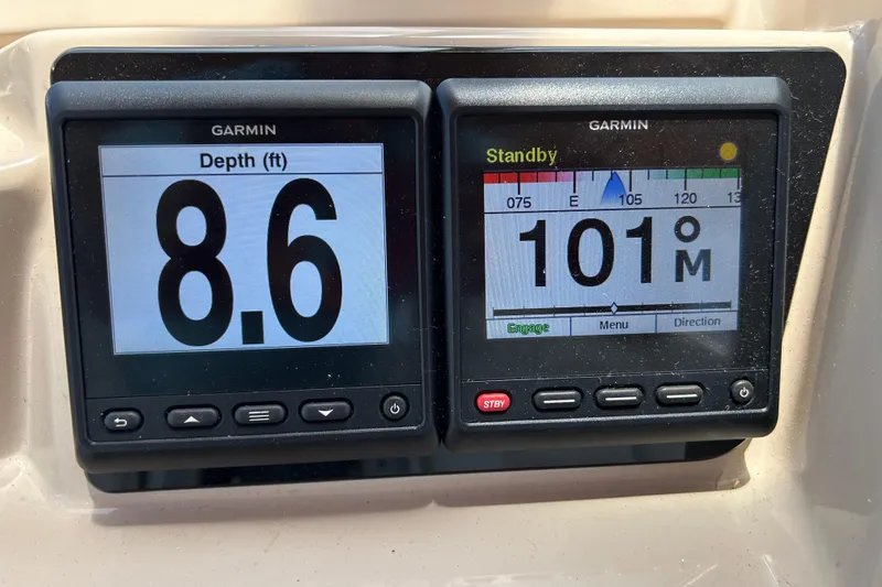 Slide: The Image of Garmin displays on 2005 Carver 36 Motor Yacht showing depth and heading information. - 30