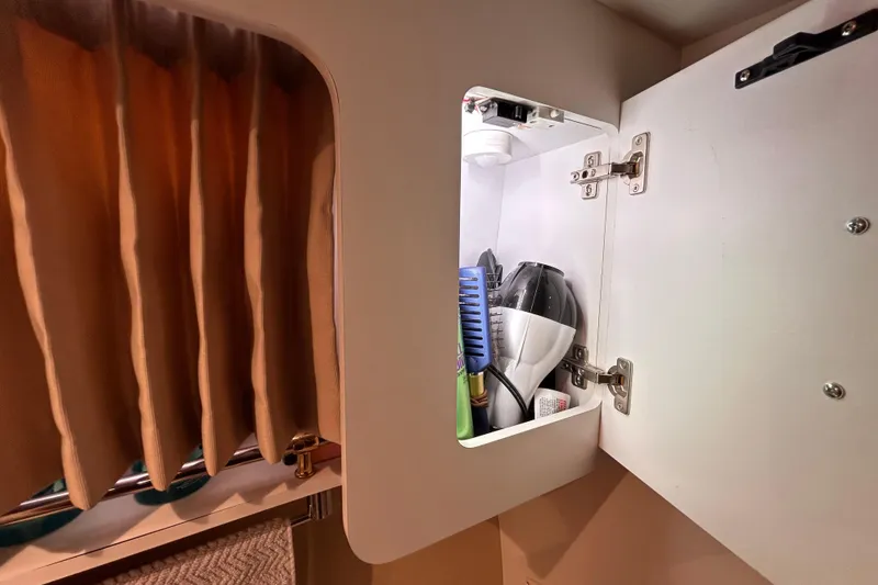 Slide: The Image of Open cabinet in 2005 Carver 36 Motor Yacht with grooming items inside. - 128