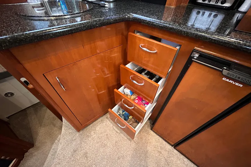 Slide: The Image of Kitchen area of 2005 Carver 36 Motor Yacht with open drawers and mini fridge. - 79