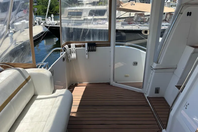 Slide: The Image of Interior view of a 2005 Carver 36 Motor Yacht with seating and dockside view. - 18