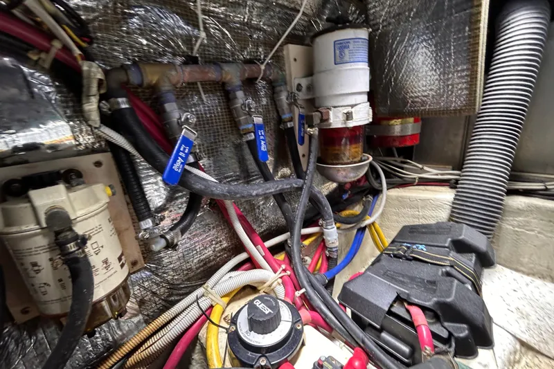 Slide: The Image of Engine room of a 2005 Carver 36 Motor Yacht with visible wiring and components. - 134