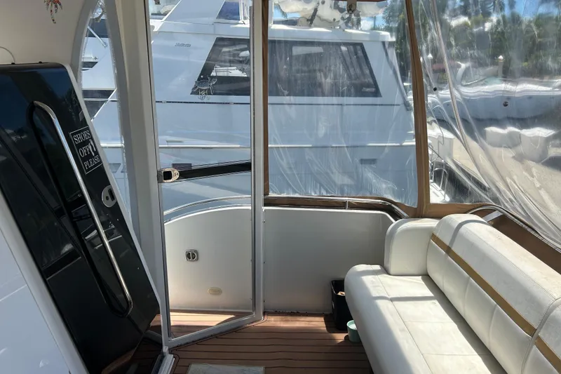 Slide: The Image of Interior view of a 2005 Carver 36 Motor Yacht with seating and clear enclosure. - 21