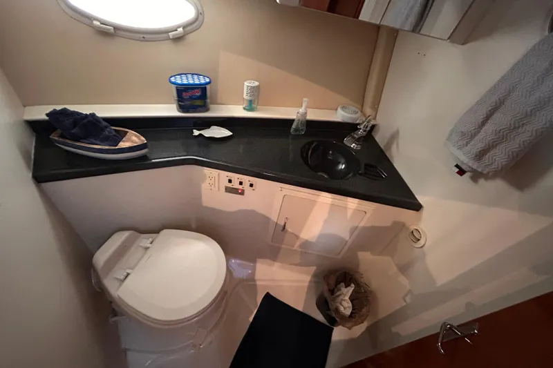 Slide: The Image of Bathroom interior of 2005 Carver 36 Motor Yacht with toilet, sink, and countertop accessories. - 103