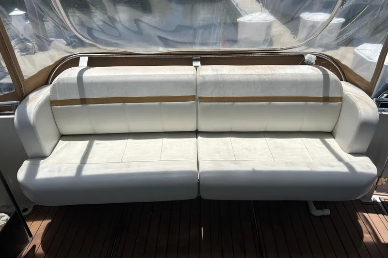 Slide: The Image of White leather seating on 2005 Carver 36 Motor Yacht deck, under clear canopy. - 19
