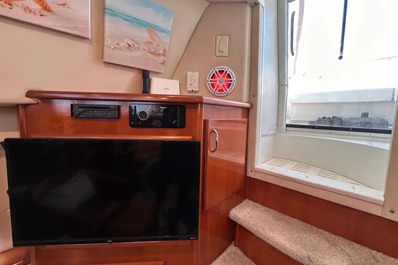 Slide: The Image of Interior of 2005 Carver 36 Motor Yacht with TV, audio system, and stairs. - 136