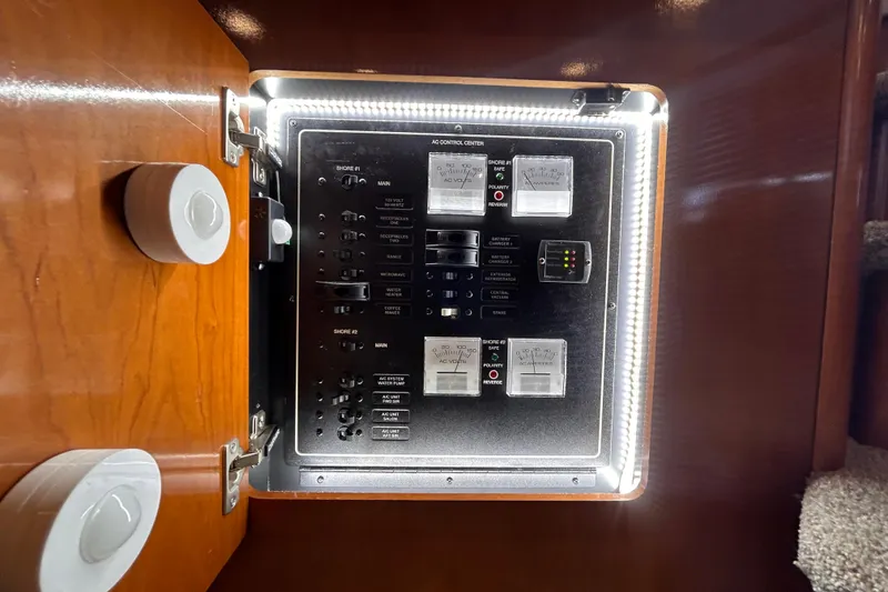 Slide: The Image of Electrical control panel inside a 2005 Carver 36 Motor Yacht, illuminated and detailed. - 113