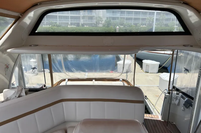 Slide: The Image of Interior view of 2005 Carver 36 Motor Yacht with white seating and marina backdrop. - 54