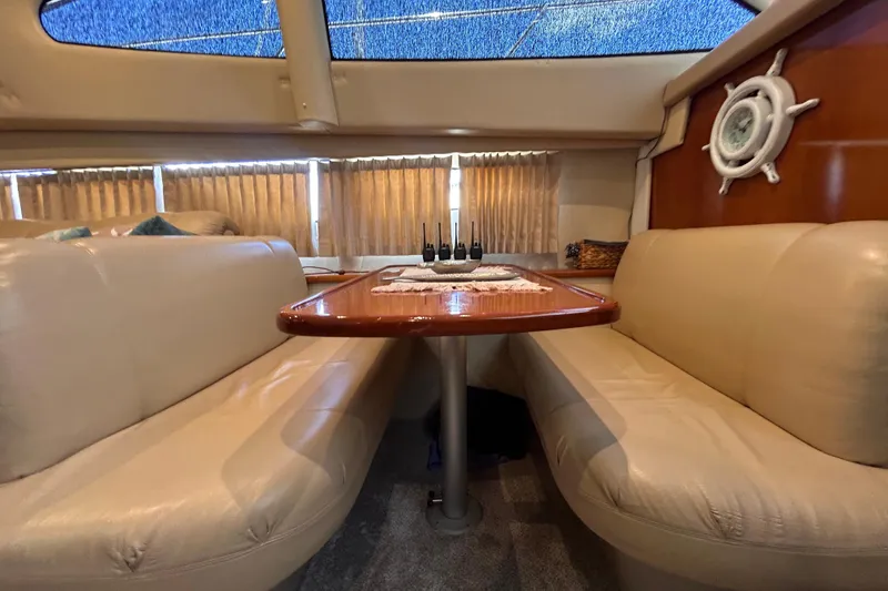 Slide: The Image of Interior of 2005 Carver 36 Motor Yacht with plush seating and wooden table. - 91