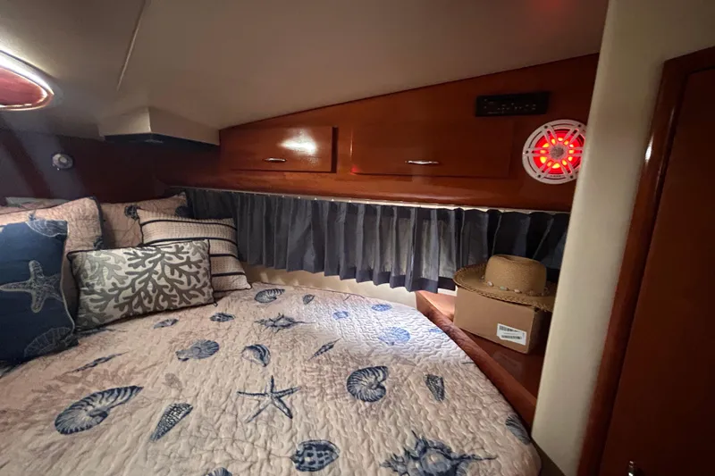Slide: The Image of Cozy cabin interior of 2005 Carver 36 Motor Yacht with nautical-themed bedding. - 99