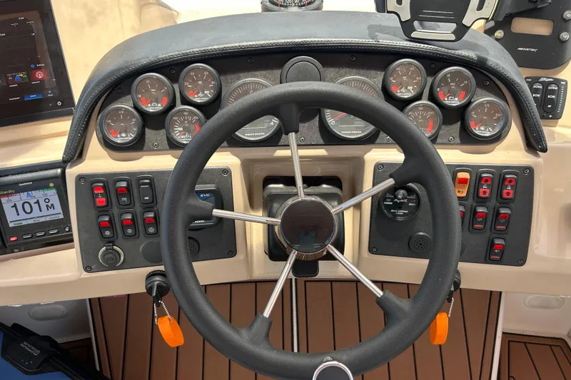 Slide: The Image of Dashboard of a 2005 Carver 36 Motor Yacht with steering wheel and gauges. - 32