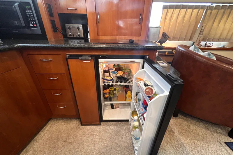 Slide: The Image of Kitchen area of a 2005 Carver 36 Motor Yacht with open fridge. - 76