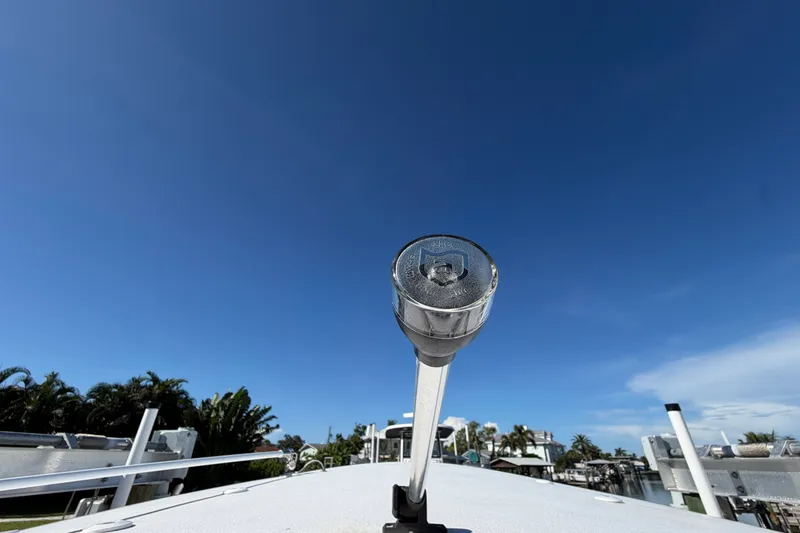 Slide: The Image of Close-up of a 2025 Sea Hunt Gamefish 27CB boat detail under a clear blue sky. - 80