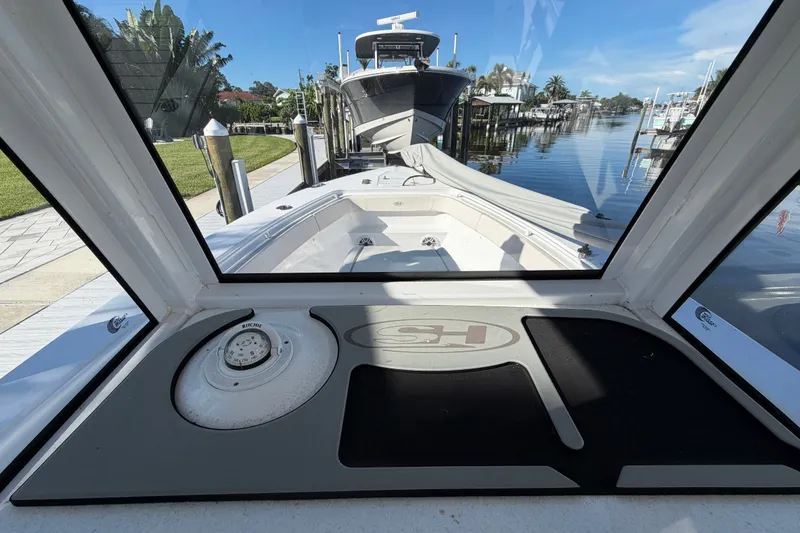 Slide: The Image of 2025 Sea Hunt Gamefish 27CB boat interior view with compass and docked marina. - 29