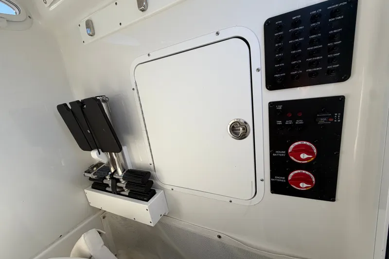 Slide: The Image of 2025 Sea Hunt Gamefish 27CB boat interior with control panel and storage compartment. - 42