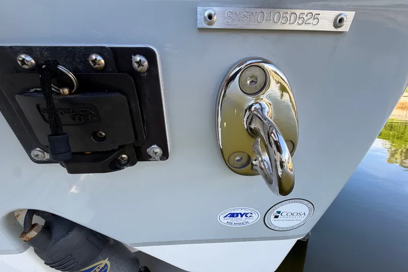 Slide: The Image of 2025 Sea Hunt Gamefish 27CB boat stern with hardware and certification stickers. - 82