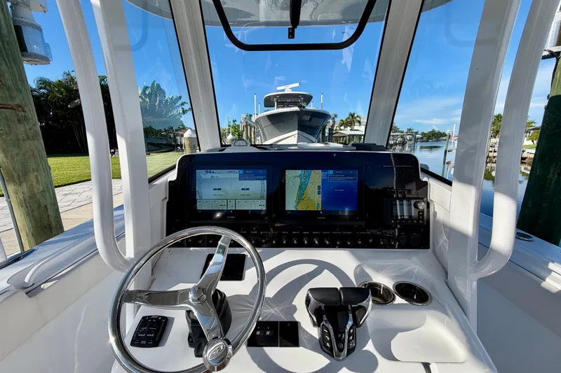 Slide: The Image of Interior view of 2025 Sea Hunt Gamefish 27CB boat cockpit with navigation screens. - 27