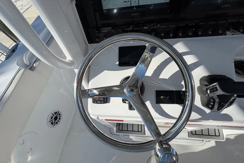 Slide: The Image of Steering wheel and controls of 2025 Sea Hunt Gamefish 27CB boat cockpit. - 34
