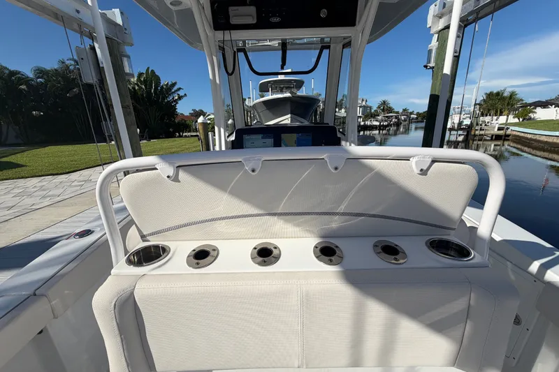 Slide: The Image of 2025 Sea Hunt Gamefish 27CB boat interior with rod holders and seating. - 15