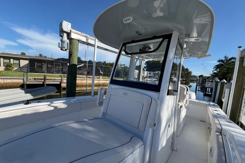 Slide: The Image of 2025 Sea Hunt Gamefish 27CB boat docked, showcasing sleek design and spacious deck. - 54
