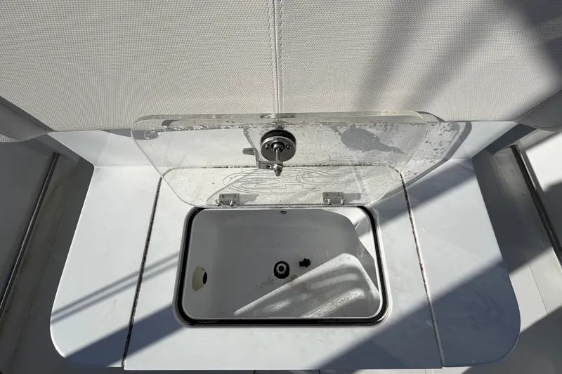 Slide: The Image of 2025 Sea Hunt Gamefish 27CB livewell with open lid, showcasing interior design. - 16