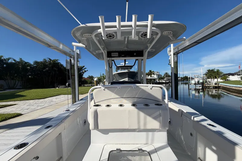 Slide: The Image of 2025 Sea Hunt Gamefish 27CB boat docked, showcasing spacious deck and sleek design. - 19