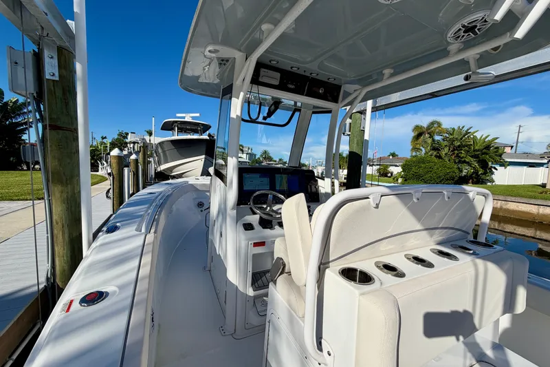 Slide: The Image of 2025 Sea Hunt Gamefish 27CB boat docked, featuring modern helm and seating. - 23
