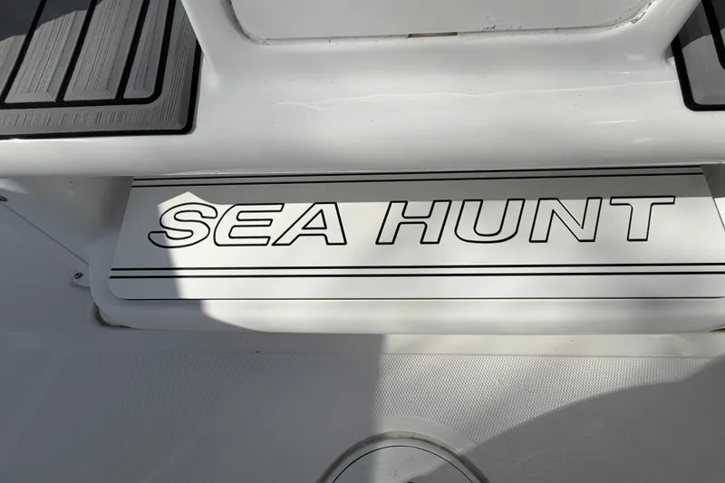Slide: The Image of 2025 Sea Hunt Gamefish 27CB boat deck with logo in sunlight. - 32